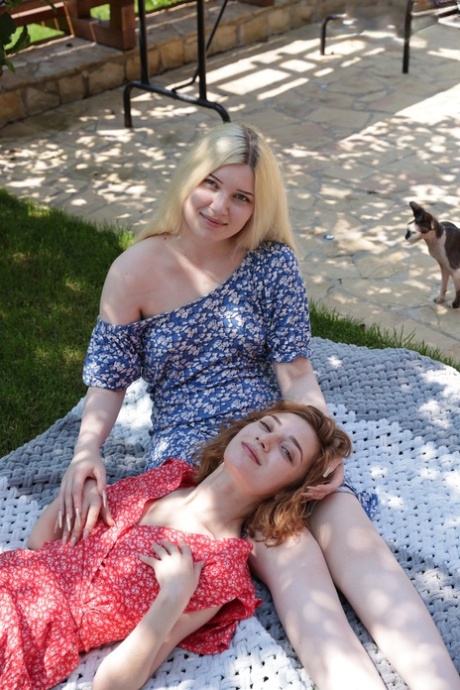 Teen lesbians Suna and Atika get each other bare naked in a backyard