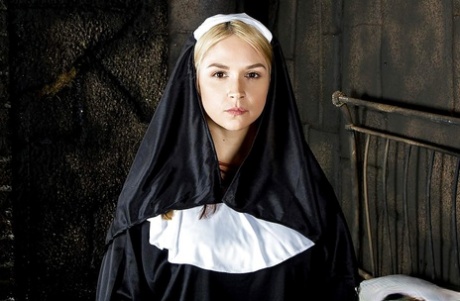 Cosplay solo girl Sara Sloane strips off nun's uniform for pornstar shoot