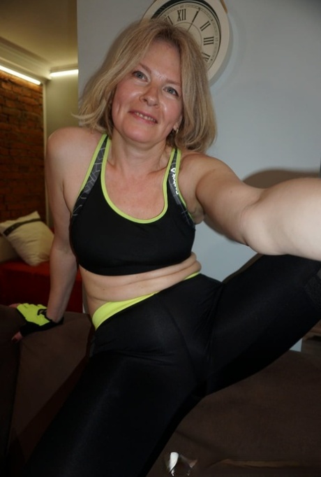 Mature blonde amateur flaunts her big ass while posing in sexy outfits